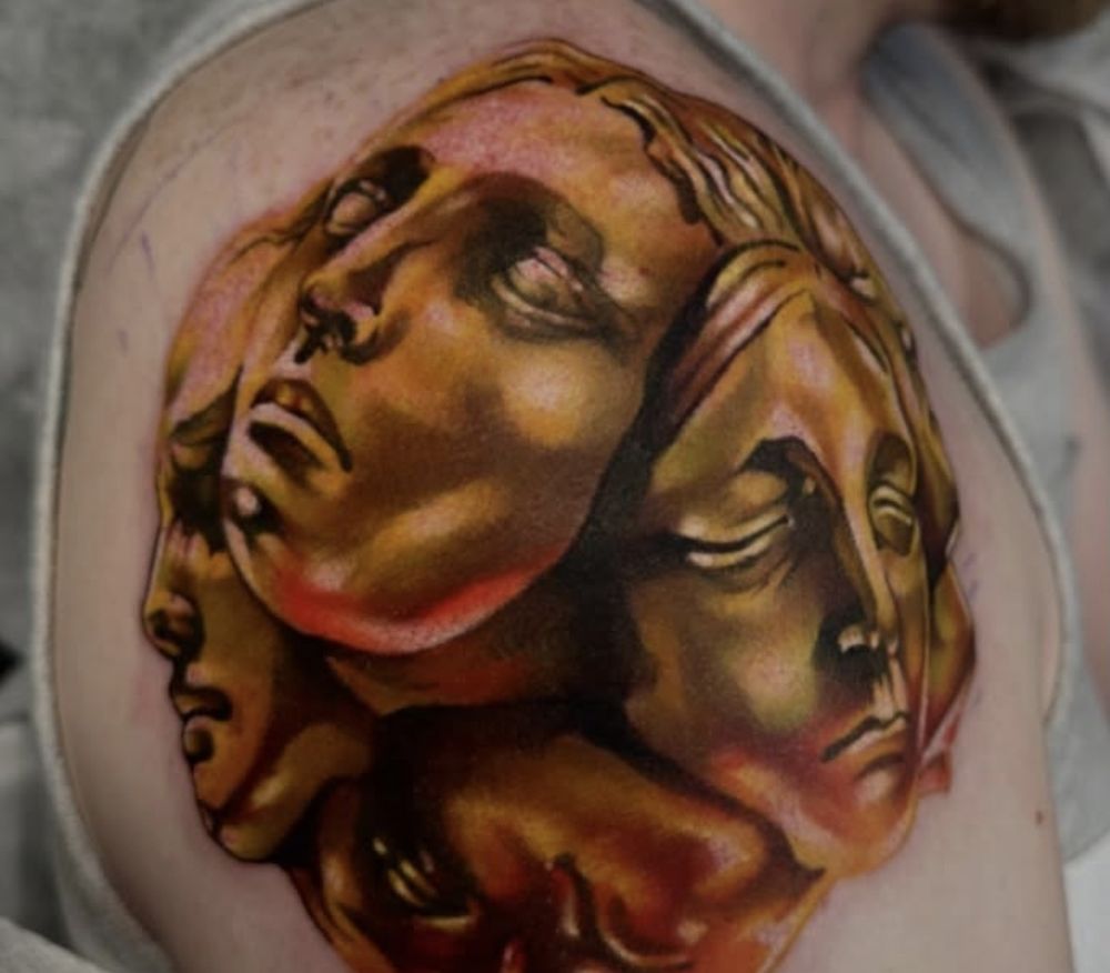 Gold color realism tattoo of the Exalted Orb from Path of Exile on a shoulder